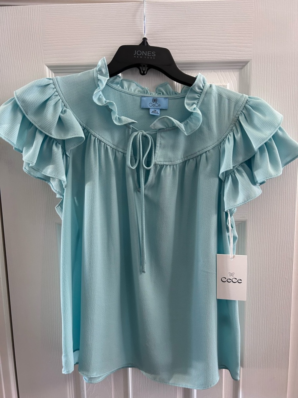 CeCe light blue, double Flutter Sleeve Blouse with Ruffled Neck and Tie Front.